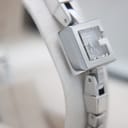 Another side view of the Gucci 102 G-frame watch case and bracelet, highlighting the polished finish.