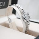 Angled view of the Gucci 102 G-frame watch on its display stand, within its original Gucci box.