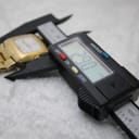 Digital caliper measuring the watch case, displaying a precise diameter of 29.0mm.