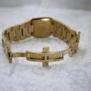 View of the integrated gold-tone bracelet with its deployant clasp open.