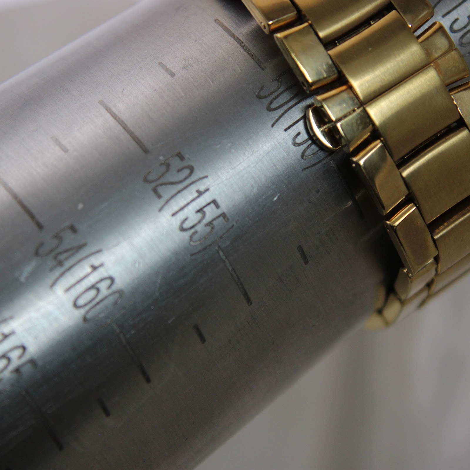 Watch bracelet wrapped around a wrist sizing gauge, indicating a wrist size of approximately 155mm or 15.5cm.