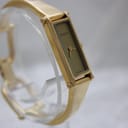 Another angled side view of the Gucci 1500L, showcasing the profile of the gold-tone case and the polished finish of the bangle.