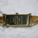Close-up of the watch case back, clearly showing the engravings "GUCCI 1500 L SWISS MADE STAINLESS STEEL 1246380".