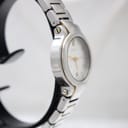 Angled side view of the Gucci 8900L watch, showcasing the polished bezel and integrated two-tone bracelet links.