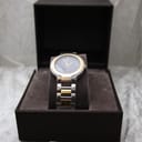 Front view of the Gucci 8900M watch presented within its original dark brown Gucci display box.