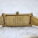 Close-up of the rectangular case back of the Gucci 1500L, showing engraved 'Gucci 1500 L Swiss Made Stainless Steel' and serial number.