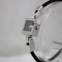 Angled close-up view of the Gucci 102 watch, highlighting the G-shaped crown detail and the polished stainless steel case.