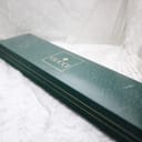 Top-down view of the original green Gucci watch box with the gold embossed 'GUCCI' logo and brand symbol.