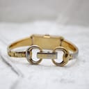 Close-up of the Gucci signed two-tone bracelet clasp, showing the interlocking G logo and "GUCCI" engraving.