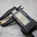Digital caliper measuring the watch case, displaying a precise reading of 14.0 mm for the case diameter.