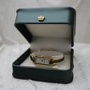 The Gucci 109 watch resting inside a dark green presentation box with a crown emblem.