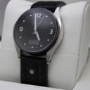 Angled front view of the Junghans Mega Solar watch on a white display stand.