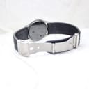 View of the watch's black perforated leather strap with its brushed stainless steel deployment clasp open.