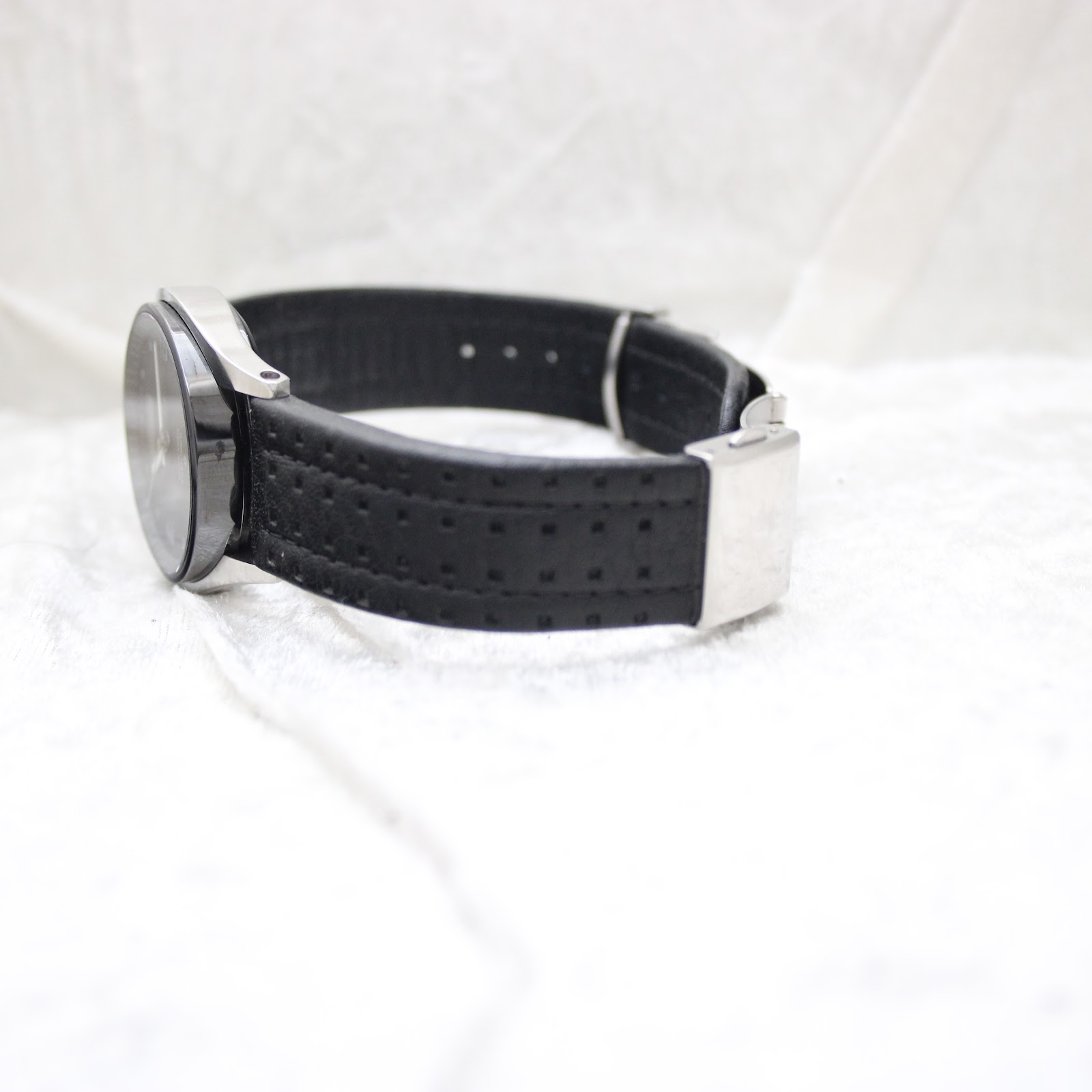Side view of the watch strap, showing the construction and the case back details.
