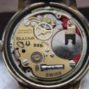 Close-up internal view of the Bulova 9X8 Swiss quartz movement with an installed battery.