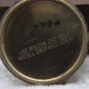 Interior view of the case back, showing instructions for battery installation and a serial number "3774".