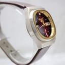 Another side view of the Rhino watch on a stand, showing the case profile and the brown leather strap.