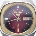 Macro close-up of the Rhino watch dial, revealing the luminous hands, applied indices, diamond-style 12 o’clock marker, day/date window, 'shockproof' text, and sharkfin logo.