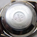 Close-up of the stainless steel case back, engraved with 'Stainless steel back', 'dust proof', 'automatic', 'Rhino' logo, and serial number '65180'.