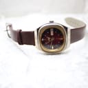 Full view of the Rhino automatic watch with its brown leather strap extended, presented on a light background.
