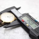 Close-up showing a digital caliper measuring the watch case diameter at precisely 35.0 mm.