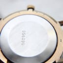 Close-up of the stainless steel case back with serial number, showing "Au5" marking on lug.