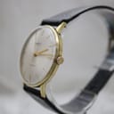 Second angled side view of the Mainstay watch, focusing on the gold-plated case and crown.