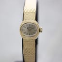 Front view of gold-tone Rotary ladies' watch with champagne dial on a black watch stand.