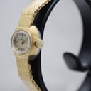Side-angled view of the Rotary watch, showing the fluted crown and integrated bracelet.