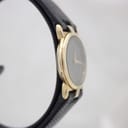 Another side profile view of the gold-plated Gucci case, showing its slim design.