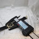 Digital caliper measuring the Gucci watch case diameter at 24.0mm.