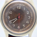Close-up of the Roamer dial, revealing the heavy brown patina, original numerals, and red seconds hand.