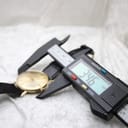 Digital caliper measuring the case diameter of the Mondaine watch, showing a reading of 34.6mm.