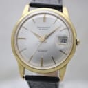 Front view of Aristocrat watch with gold-tone case, silver sunburst dial, and black leather strap.