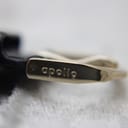 Close-up of the 'Apollo' signed buckle on the black leather strap.