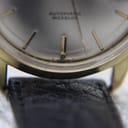 Extreme close-up of the lower part of the dial and crystal, showing 'T SWISS T' marking and part of the black leather strap.
