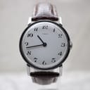 Front view of the Timex vintage dress watch with white dial and black Arabic numerals on a display stand.