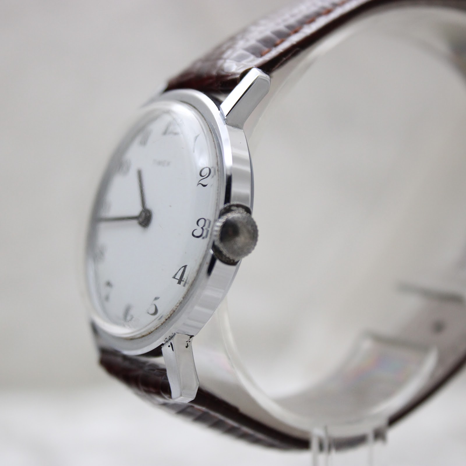 Angled side view of the Timex watch showing the chrome-plated case and crown on the right.