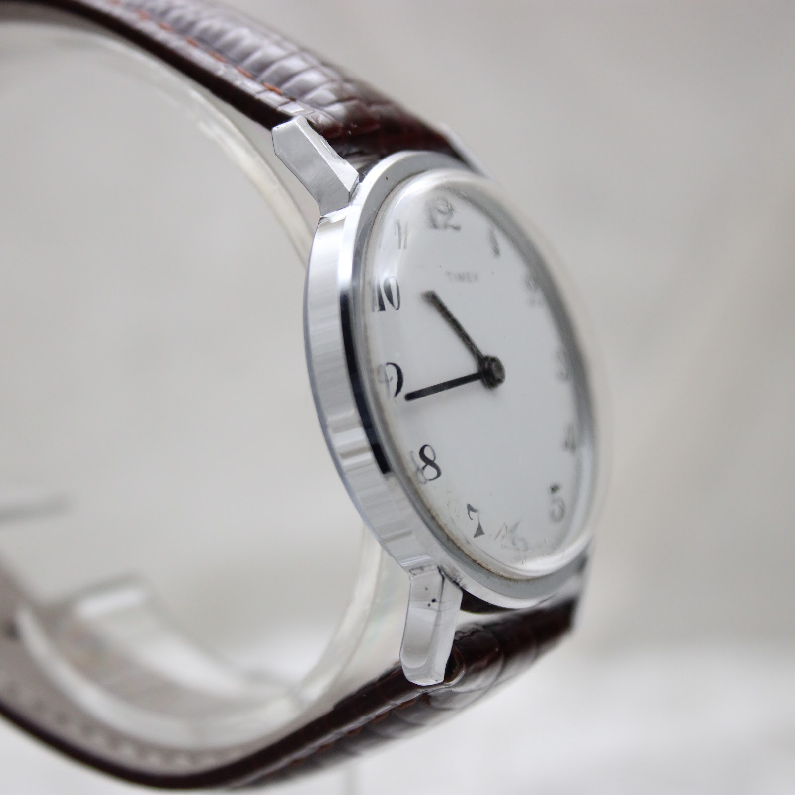 Side profile view of the Timex watch highlighting the slim case design and acrylic crystal.