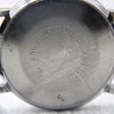 Close-up of the watch's stainless steel case back with 'STAINLESS STEEL BACK' engraved in a circular pattern.