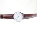 Full overhead view of the Timex watch with its burgundy brown leather strap extended on a white background.