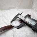 Digital caliper measuring the case diameter of the Timex watch, displaying 34.9 mm.