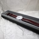 The Timex vintage dress watch with its strap neatly placed inside a generic rectangular watch box.