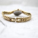 Close-up of the gold-tone integrated bracelet clasp from the rear