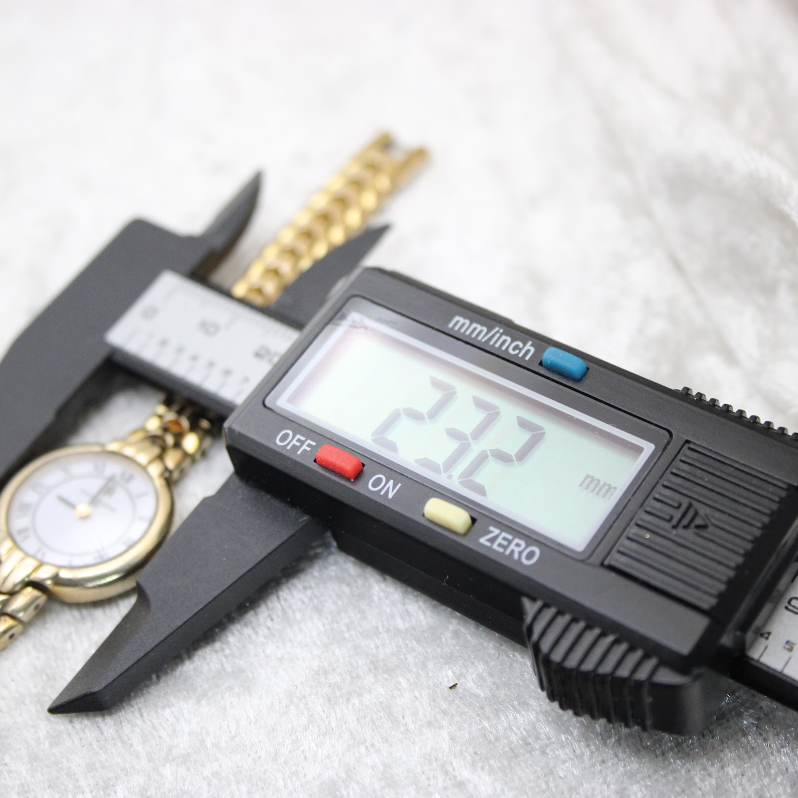 Digital caliper measuring the case diameter of the Saint-Honoré Paris watch, showing 23.2mm