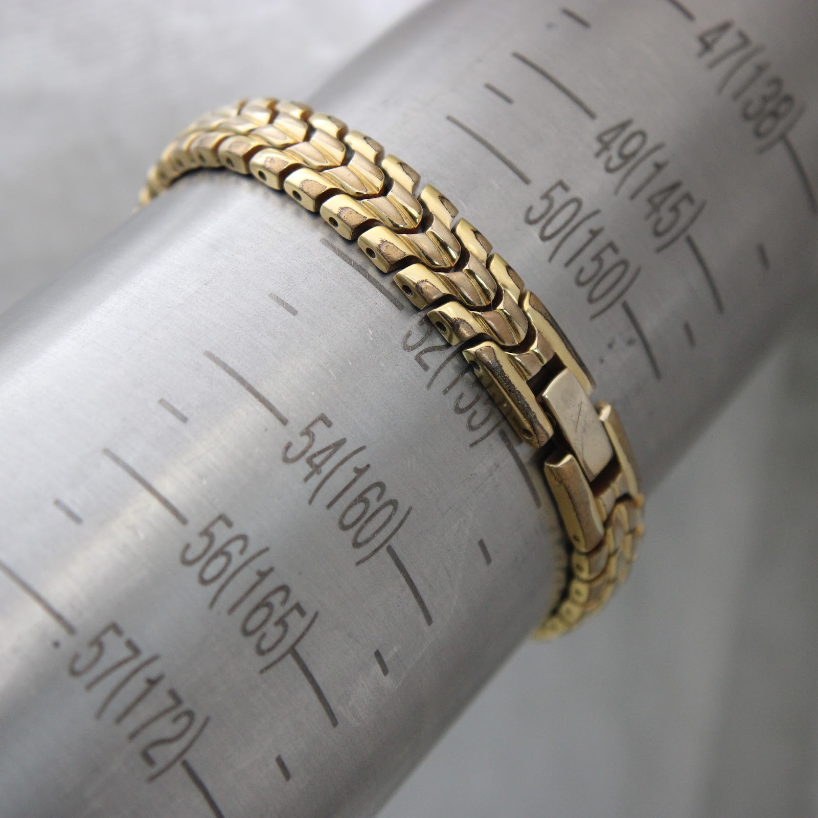 The watch bracelet on a wrist sizing gauge, indicating a wrist circumference of 150mm (15cm)