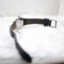 Angled view of the Mondaine watch from the back, showing the strap and buckle