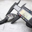 Digital caliper measuring the case diameter of the Mondaine watch, showing 30.4mm