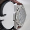 Opposite side view of the watch case highlighting the compass bezel markings and robust construction.