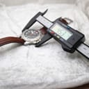 Digital caliper measuring the watch case, displaying a precise diameter of 45.3mm.